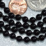 Black Tourmaline Mala Necklace featuring 108 hand-knotted Black Tourmaline beads, designed for protection and grounding. Ideal for meditation and spiritual practices, aligning with the Root Chakra, and resonating with Capricorn and Libra.