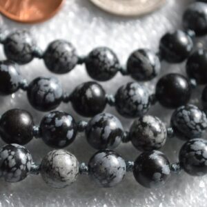 Snowflake Obsidian Mala Necklace featuring 108 hand-knotted beads, designed for grounding and emotional balance. Resonates with Capricorn and Virgo zodiac signs.