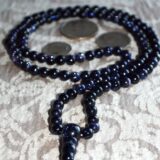 Blue Goldstone / Sandstone Mala Necklace featuring 108 hand-knotted beads, designed to activate the Throat Chakra for enhanced communication and inspiration, associated with Sagittarius energy.