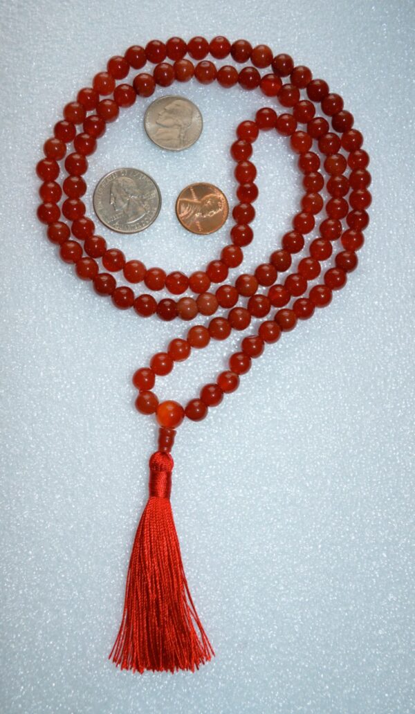 Carnelian Mala Beads Necklace featuring 108 hand-knotted beads, designed to activate the Sacral Chakra for enhanced motivation and creativity, associated with Taurus energy.