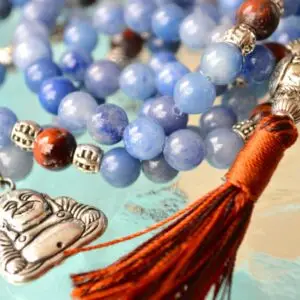 A Blue Aventurine & Buddha Charm Mala Beads Necklace featuring genuine blue aventurine beads, a Buddha charm, and connections to the Third Eye and Throat Chakras, with associations to Libra and Virgo, designed for inner peace and spiritual wisdom.