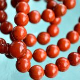 Red Jasper Mala Necklace featuring 108 hand-knotted beads, designed for grounding, strength, and Root Chakra activation. Resonates with Aries and Scorpio zodiac signs.