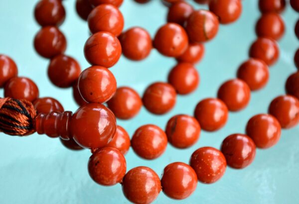 Red Jasper Mala Necklace featuring 108 hand-knotted beads, designed for grounding, strength, and Root Chakra activation. Resonates with Aries and Scorpio zodiac signs.