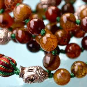 Dragon Vein Agate Mala Necklace featuring 108 hand-knotted Dragon Vein Agate beads, designed to enhance strength and creativity. Ideal for meditation and spiritual practices, aligning with the Root and Sacral Chakras, and resonating with Aries and Taurus.