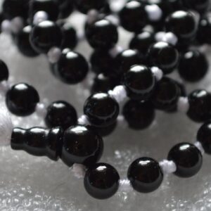 A Black Onyx Mala Necklace featuring 108 beads plus 1 guru bead. This necklace supports the Root Chakra, resonates with Capricorn and Leo, and offers protection and grounding. Handcrafted for quality and comfort, it’s suitable for meditation and spiritual practice.