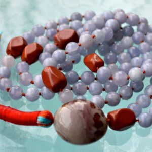 An Aquamarine & Jasper Mala Necklace featuring hand-knotted beads, designed to support the Throat and Root Chakras. Resonates with Pisces and Aries, offering communication and grounding benefits. Ideal for meditation and spiritual practices.