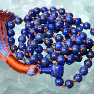 A Lapis Lazuli Mala Necklace featuring 108 beads plus 1 guru bead. This necklace supports the Third Eye and Throat Chakras, aligns with Sagittarius and Libra, and enhances intuition, communication, and self-expression. Handcrafted for quality and comfort, it's ideal for meditation and spiritual practice.