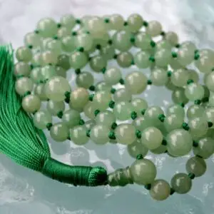 A smooth Green Aventurine Mala Necklace with 108 beads plus 1 guru bead. This necklace supports the Heart Chakra, resonates with Virgo, and promotes prosperity, emotional healing, and love. Handcrafted for comfort and quality, ideal for meditation and spiritual practice.