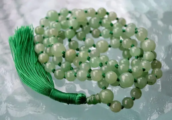 A smooth Green Aventurine Mala Necklace with 108 beads plus 1 guru bead. This necklace supports the Heart Chakra, resonates with Virgo, and promotes prosperity, emotional healing, and love. Handcrafted for comfort and quality, ideal for meditation and spiritual practice.