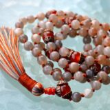 A Peach Moonstone Mala Necklace with 108 beads plus 1 guru bead. This necklace supports the Crown and Sacral Chakras, resonates with Cancer and Libra, and promotes emotional healing, creativity, and intuition. Handcrafted for comfort and quality, it’s suitable for meditation and spiritual practice.