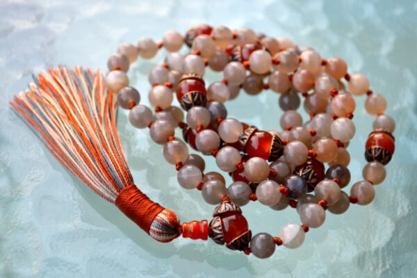 A Peach Moonstone Mala Necklace with 108 beads plus 1 guru bead. This necklace supports the Crown and Sacral Chakras, resonates with Cancer and Libra, and promotes emotional healing, creativity, and intuition. Handcrafted for comfort and quality, it’s suitable for meditation and spiritual practice.