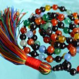 9 Planets Navratan Hand Knotted Beads Necklace, designed to balance the Root and Crown Chakras, resonating with Leo and Capricorn, representing the cosmic energies of the nine planets, perfect for spiritual growth and alignment.