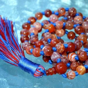 Crackled Fire Agate Mala Necklace featuring 108 hand-knotted Crackled Fire Agate beads, designed for protection and vitality. Ideal for meditation and spiritual practices, aligning with the Root and Sacral Chakras, and resonating with Aries and Scorpio.