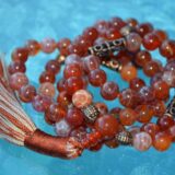 Red Fire Agate Mala Necklace designed for Root Chakra support, offering grounding, protection, and emotional balance, with stones resonating with Aries and Scorpio.