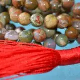 A Picture Jasper Mala Necklace with 108 beads, associated with the Root Chakra, designed for Taurus zodiac signs, promoting grounding and stability.