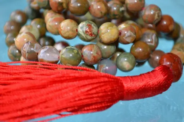 A Picture Jasper Mala Necklace with 108 beads, associated with the Root Chakra, designed for Taurus zodiac signs, promoting grounding and stability.