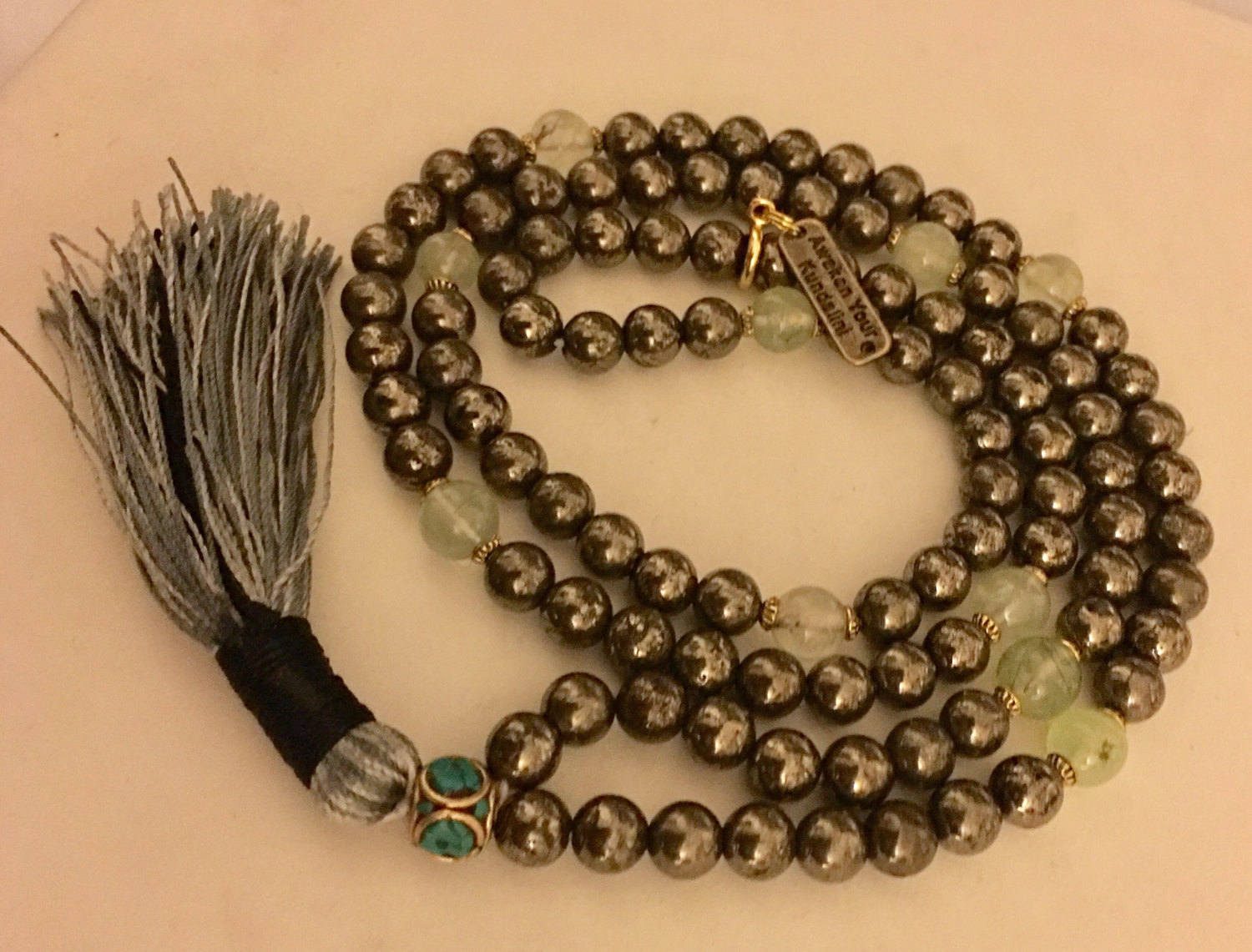 Golden Pyrite and Prehnite Mala Necklace featuring 108 hand-knotted beads, designed to activate the Solar Plexus and Heart Chakras. Perfect for Leo and Virgo, it promotes manifestation, protection, and emotional healing.