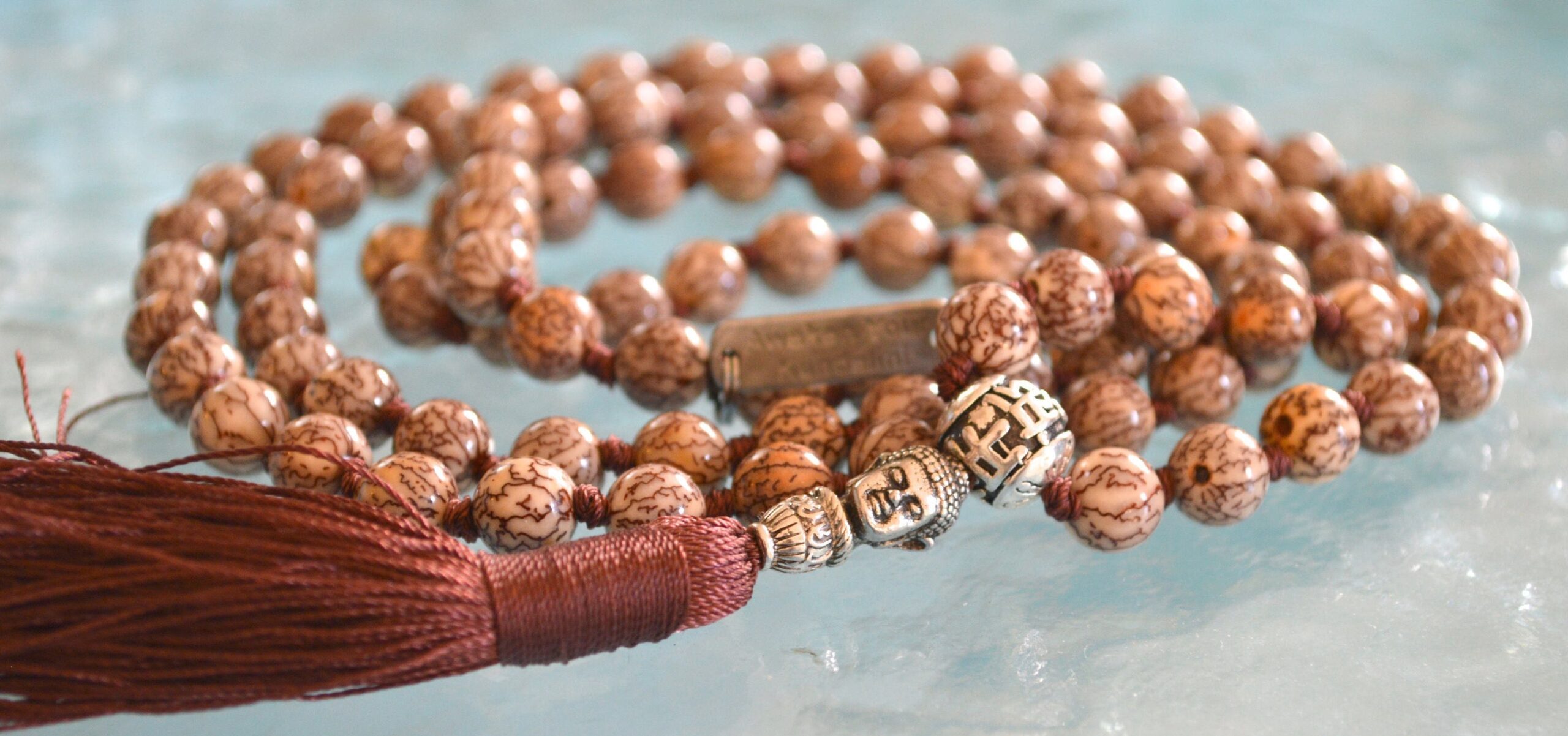 Hand-knotted Bodhi seed mala necklace with star and moon motifs, symbolizing spiritual enlightenment and cosmic connection. Ideal for meditation, featuring 108 beads for Crown Chakra balancing.