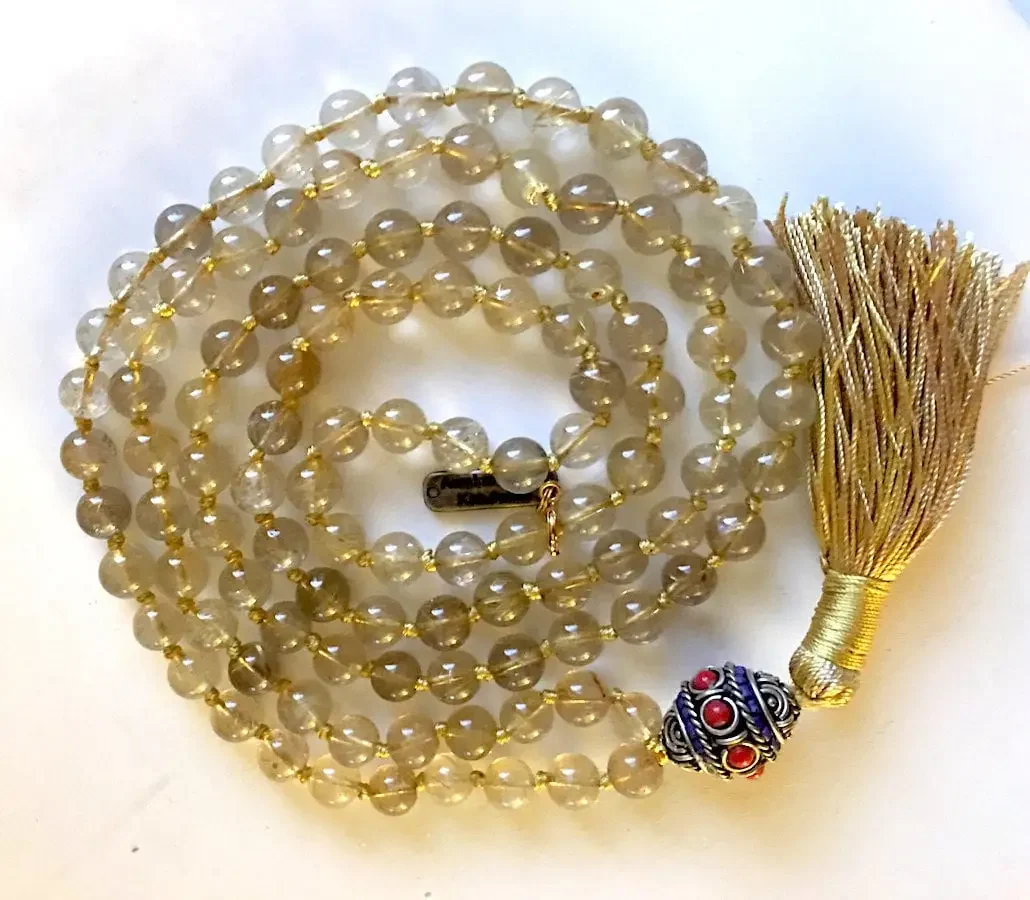 Golden Rutilated Crystal Quartz Mala Necklace with unique inclusions, designed for manifestation and abundance, supporting the Solar Plexus Chakra, associated with Leo and Taurus zodiac signs.