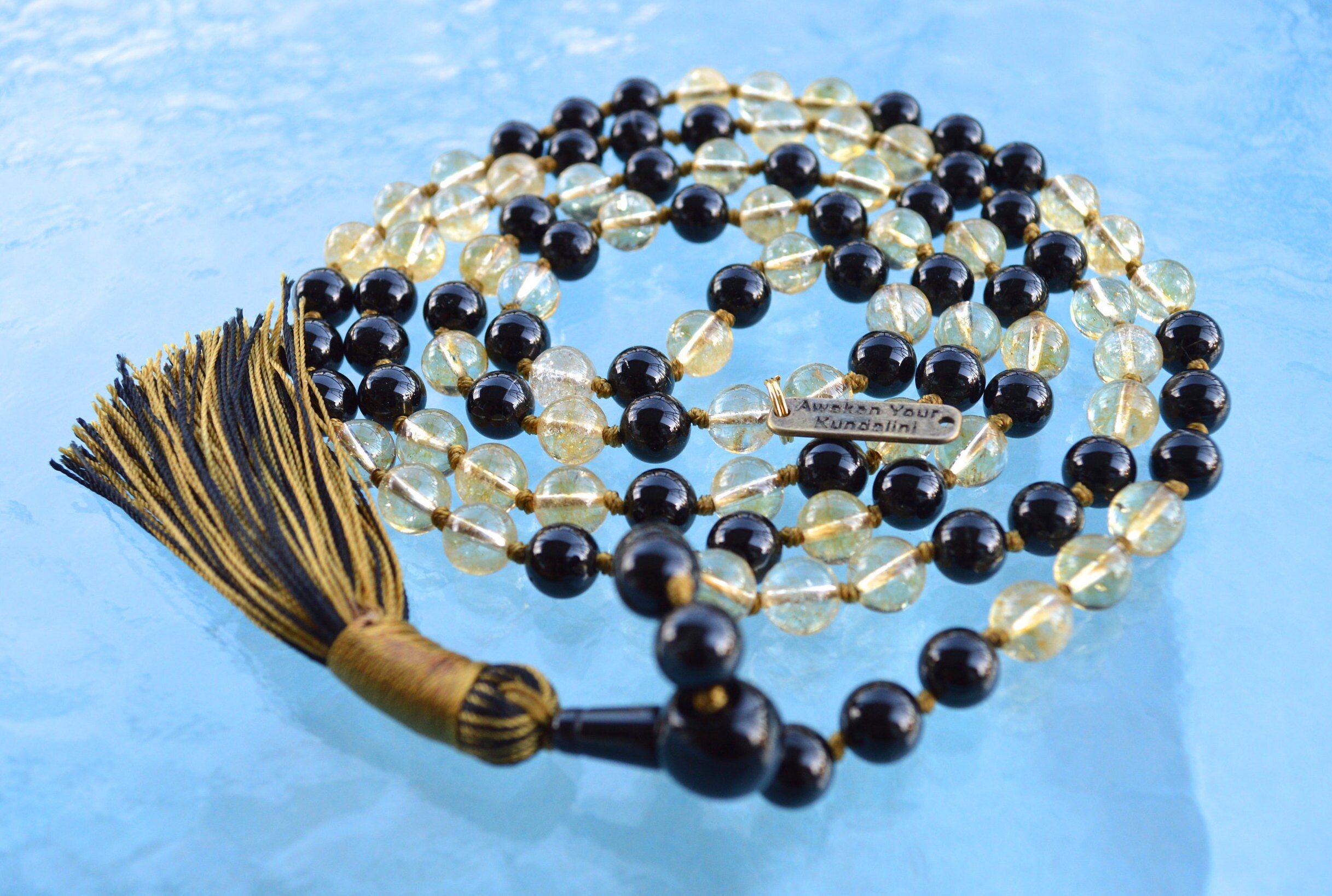  Black Tourmaline & Citrine Mala Necklace designed for Root and Solar Plexus Chakra healing, promoting protection, confidence, and abundance, resonating with Capricorn and Leo for stability and prosperity.