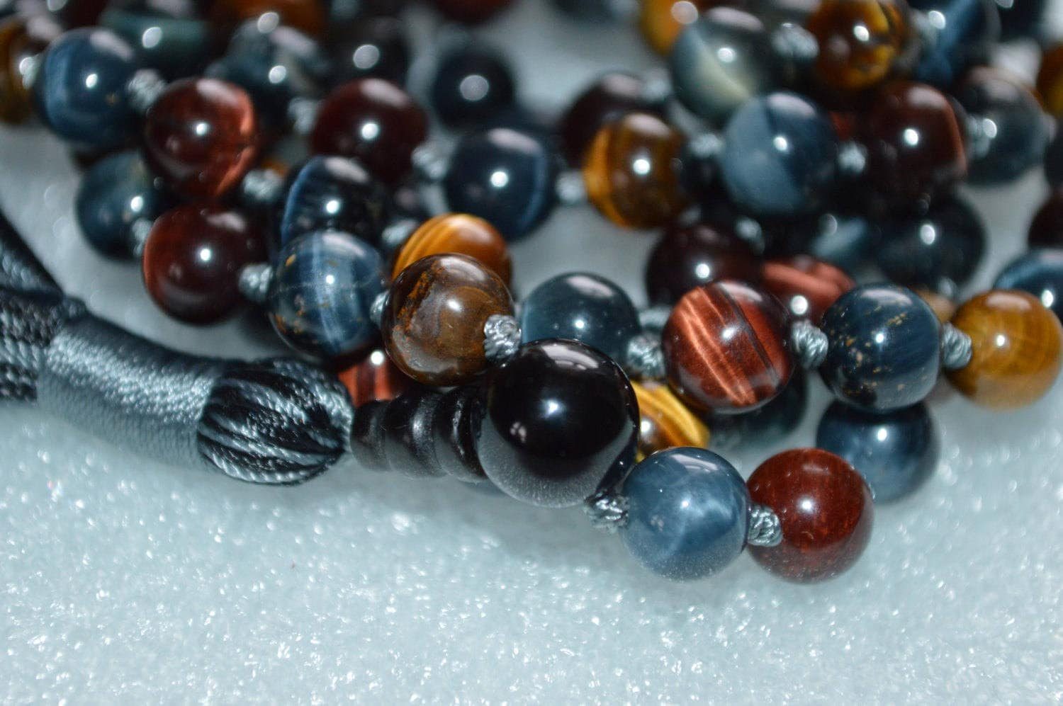 Red, Gray, Blue, Brown Hawk's Tiger Eye Mala Necklace designed for Root & Solar Plexus Chakra support, promoting courage, protection, and grounding, resonating with Scorpio and Leo sun signs.