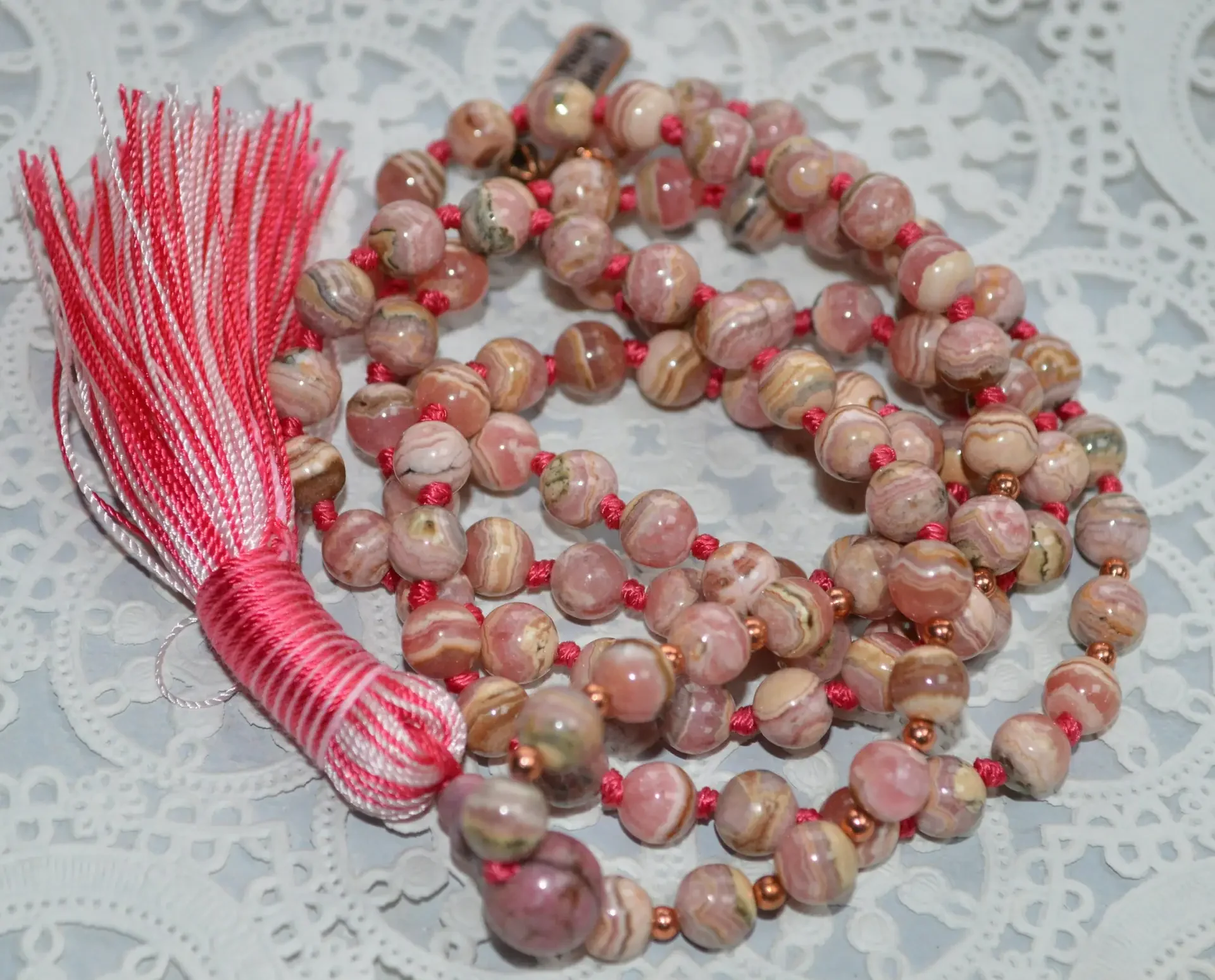 Rhodochrosite Knotted Mala Bead Necklace designed for Heart Chakra support, offering love and emotional healing, with gemstones resonating with Scorpio and Leo.