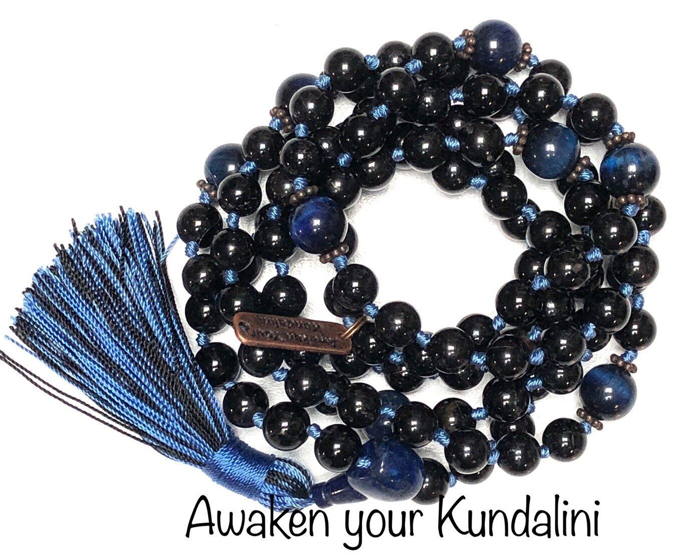 Tourmaline & Blue Tiger Eye Mala Necklace featuring 108 hand-knotted beads, combining Tourmaline for protection and Blue Tiger Eye for enhanced communication. Designed for grounding and clear expression, aligning with the Root and Throat Chakras, and resonating with Capricorn and Gemini.