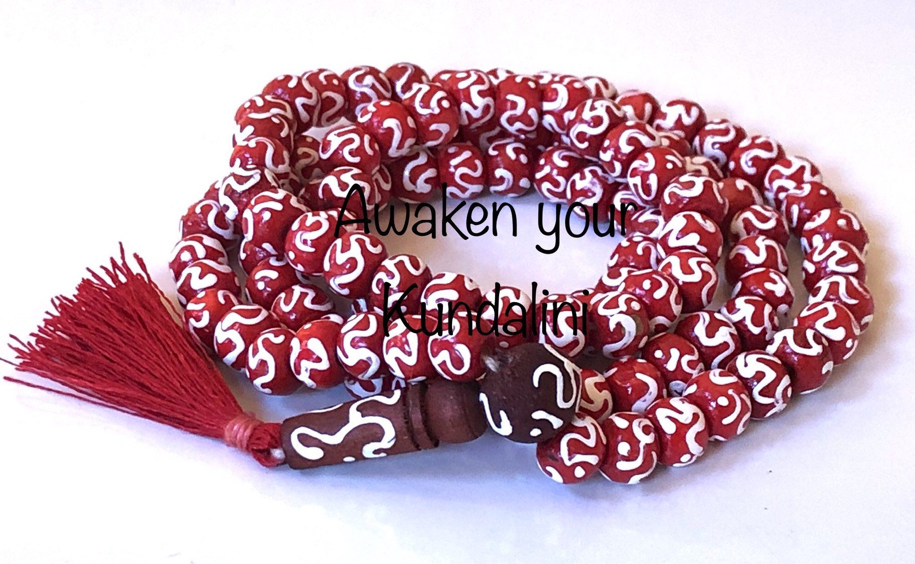 Om Beads Red Mala Necklace featuring 108 hand-knotted beads engraved with the sacred Om symbol, designed to balance the Heart and Crown Chakras. Ideal for Leo and Pisces, it promotes peace and spiritual connection.