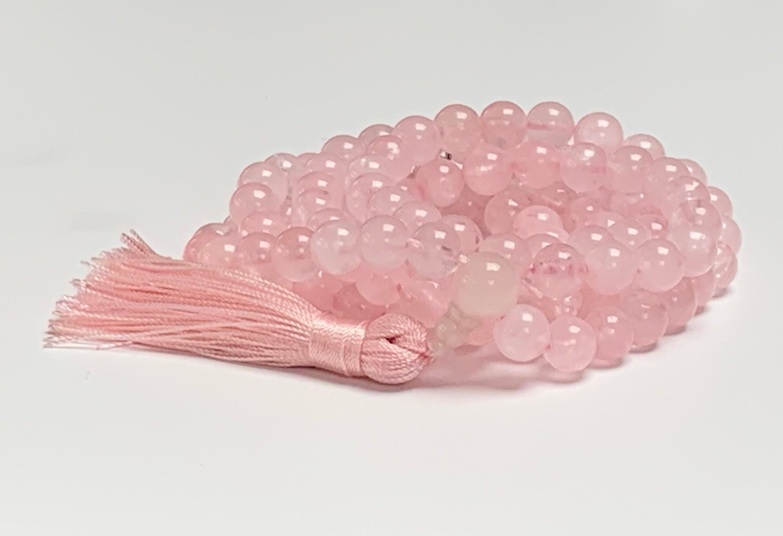 Rose Quartz Mala Necklace featuring 108 hand-knotted Rose Quartz beads, designed to promote love, compassion, and emotional healing. Ideal for meditation and spiritual practices, aligning with the Heart Chakra, and resonating with Taurus and Libra.