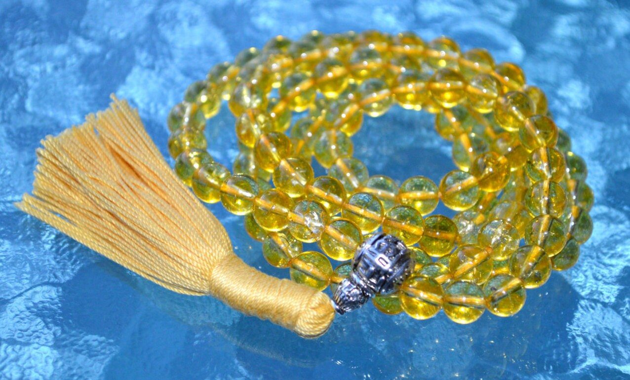 Citrine Mala Necklace featuring 108 hand-knotted Citrine beads, designed for abundance, confidence, and manifesting success. Aligns with the Solar Plexus Chakra and resonates with Aries and Gemini. Ideal for meditation and daily positivity.