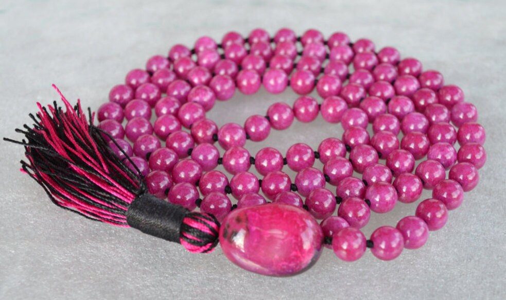 Majenta Mashan Mala Necklace featuring 108 hand-knotted Magenta Mashan jade beads, designed for balance and spiritual connection. Ideal for meditation and spiritual practices, aligning with the Root and Crown Chakras, and resonating with Scorpio and Capricorn.