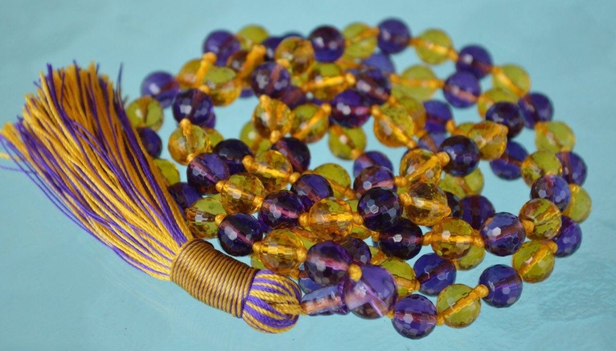 Ametrine, Amethyst, and Citrine mala beads necklace featuring 108 beads, designed for manifestation and abundance, with a focus on Third Eye and Solar Plexus chakra alignment.