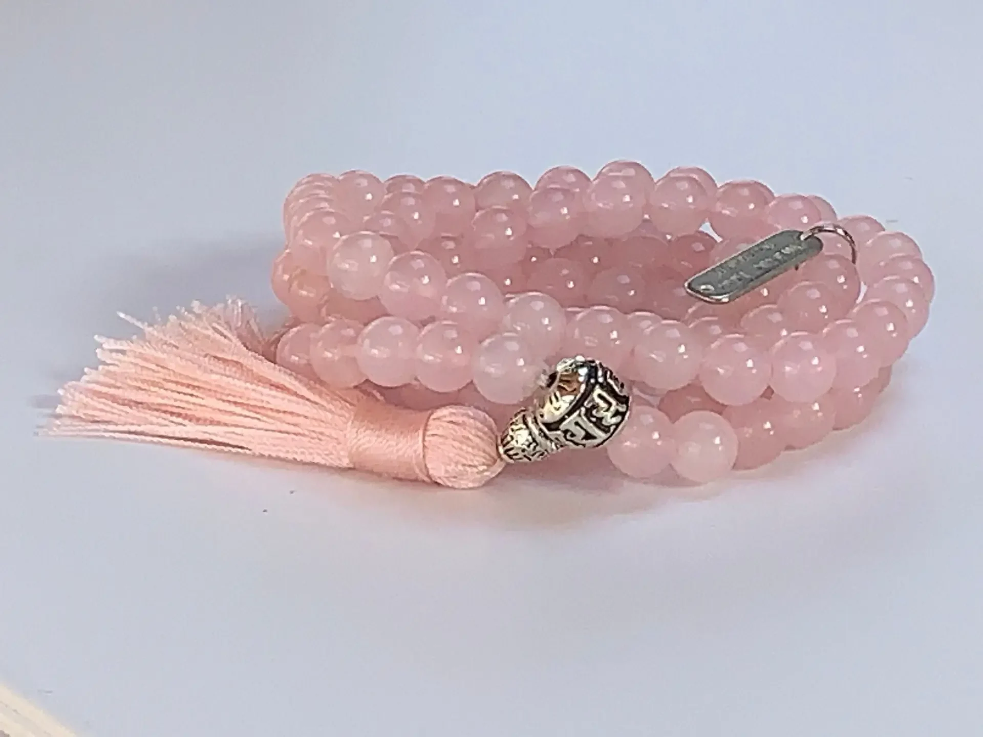 A Rose Quartz Mala Necklace with 108 beads plus 1 guru bead. Supports the Heart Chakra, promoting love and compassion. Smooth, pink gemstones resonate with Taurus and Libra for emotional balance. Handcrafted for comfort, ideal for meditation and spiritual practice