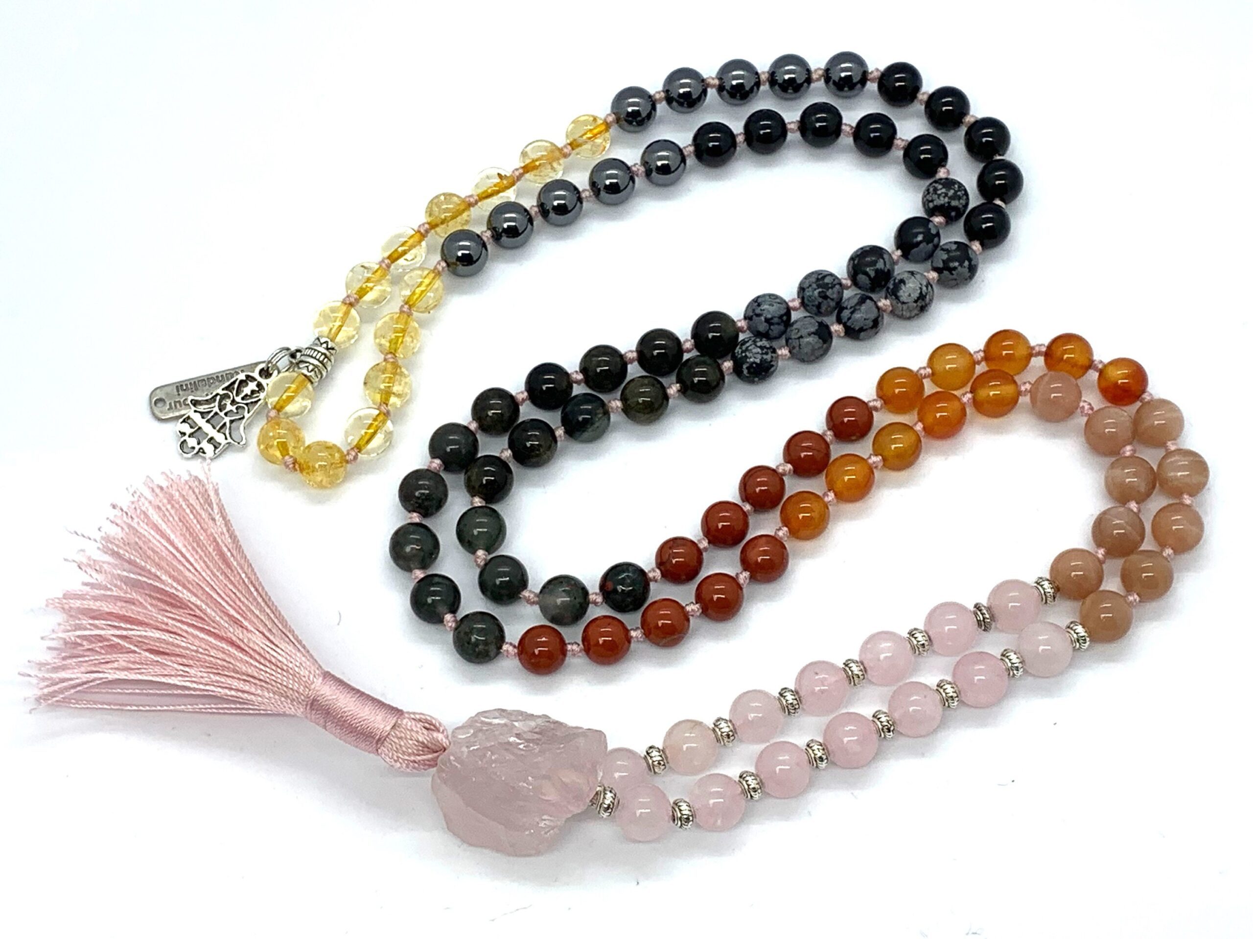 Rose Quartz & Carnelian Mala Necklace with 108 beads, copper guru bead, and black tassel, promoting emotional healing and vitality.