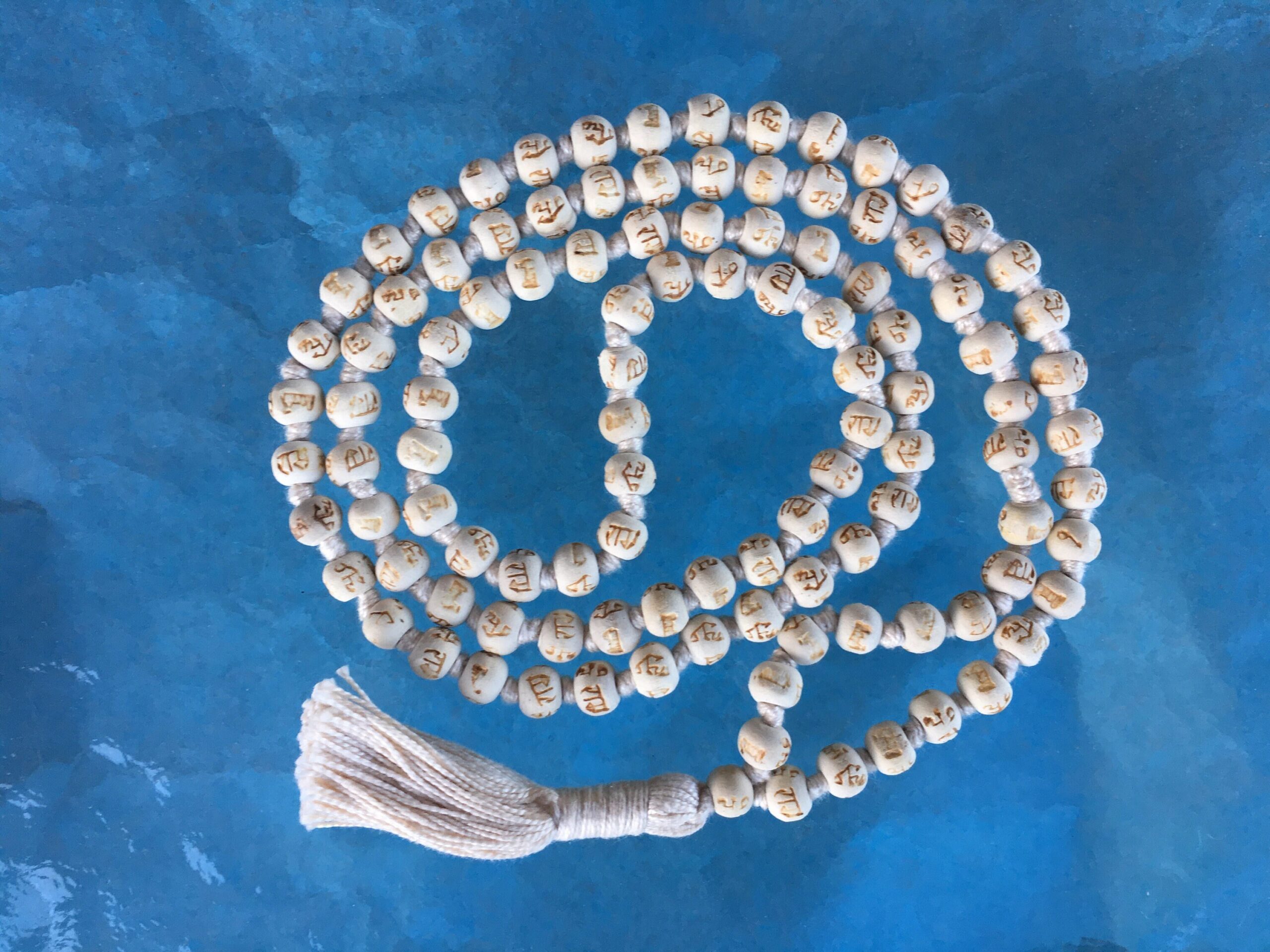 Hare Rama Tulsi Mala featuring inscribed beads, aligning with the Heart Chakra, fostering devotion and spiritual growth, handcrafted in the USA.