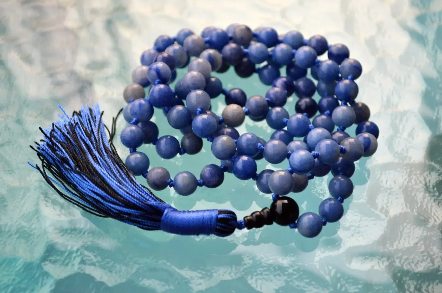 cA Blue Aventurine Mala Necklace with 108 beads, associated with the Throat Chakra, designed for Gemini zodiac signs, promoting communication and clarity.