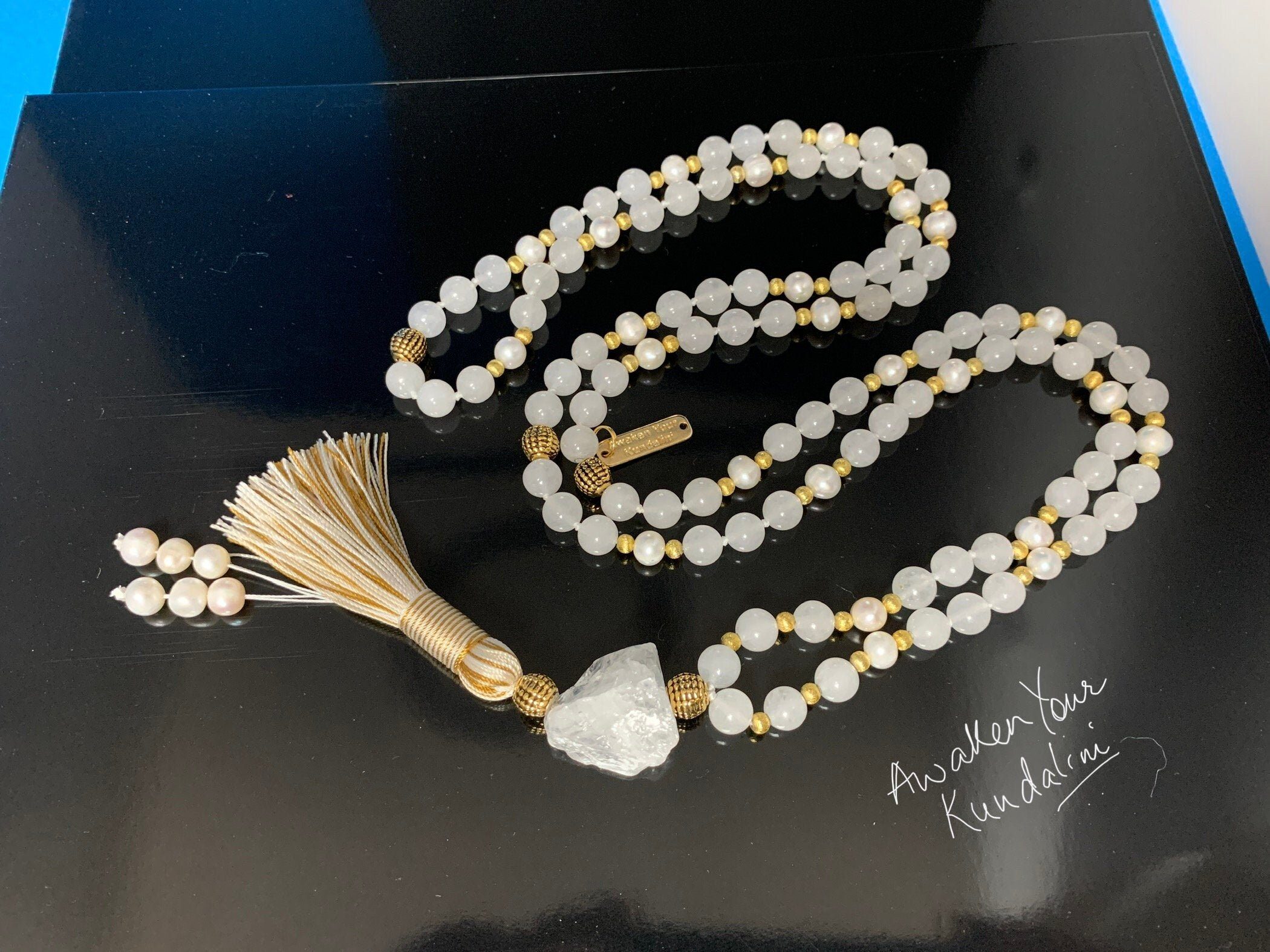 Moonstone & Pearl Mala Necklace featuring natural moonstone and pearl beads, hand-knotted, aligned with Crown and Third Eye Chakras for intuition and emotional balance.