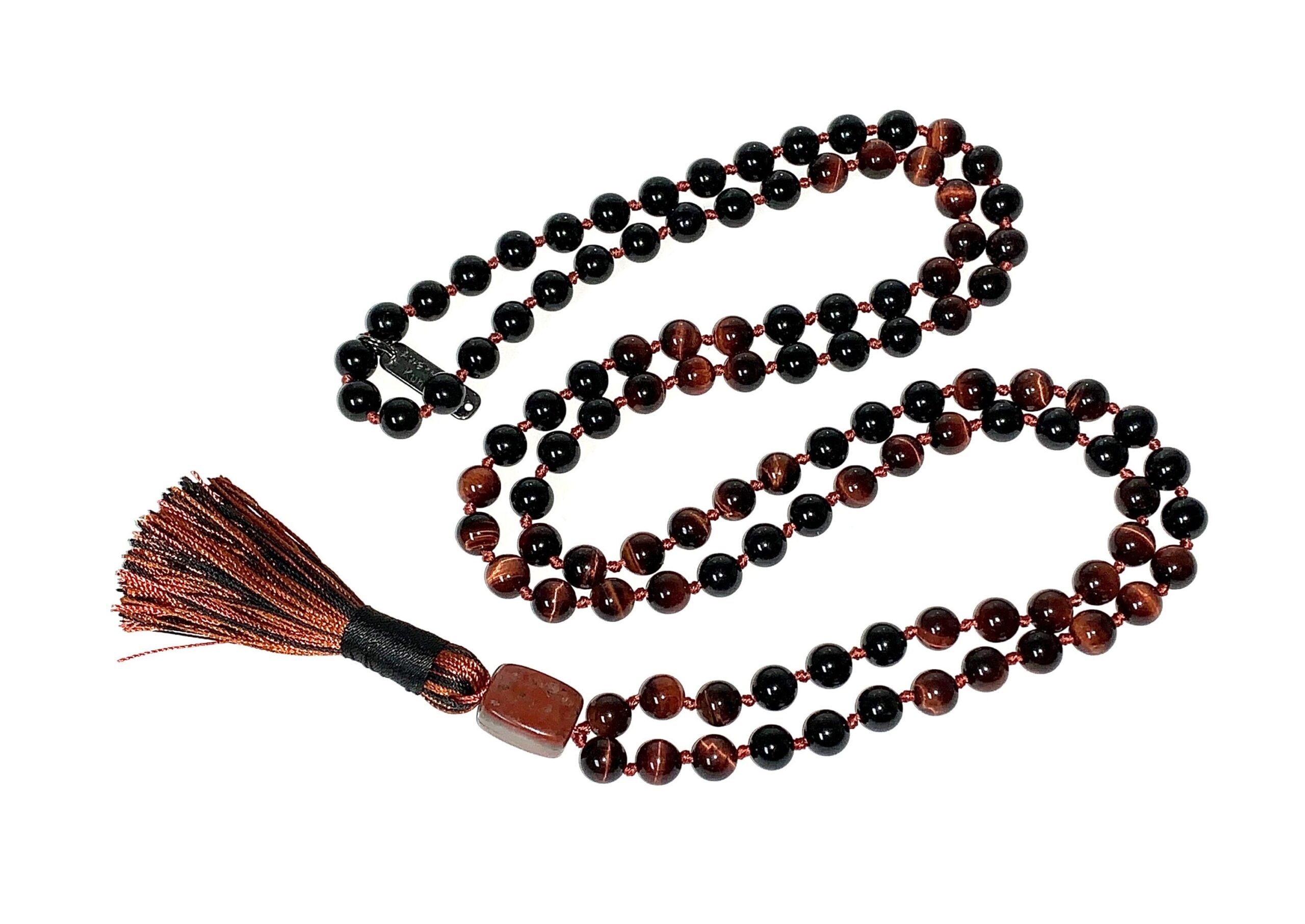 Red Tiger Eye & Tourmaline Mala Necklace featuring 108 hand-knotted beads, designed to promote protection, confidence, and grounding. Ideal for meditation and spiritual practices, aligning with the Root and Solar Plexus Chakras, and resonating with Aries and Capricorn.