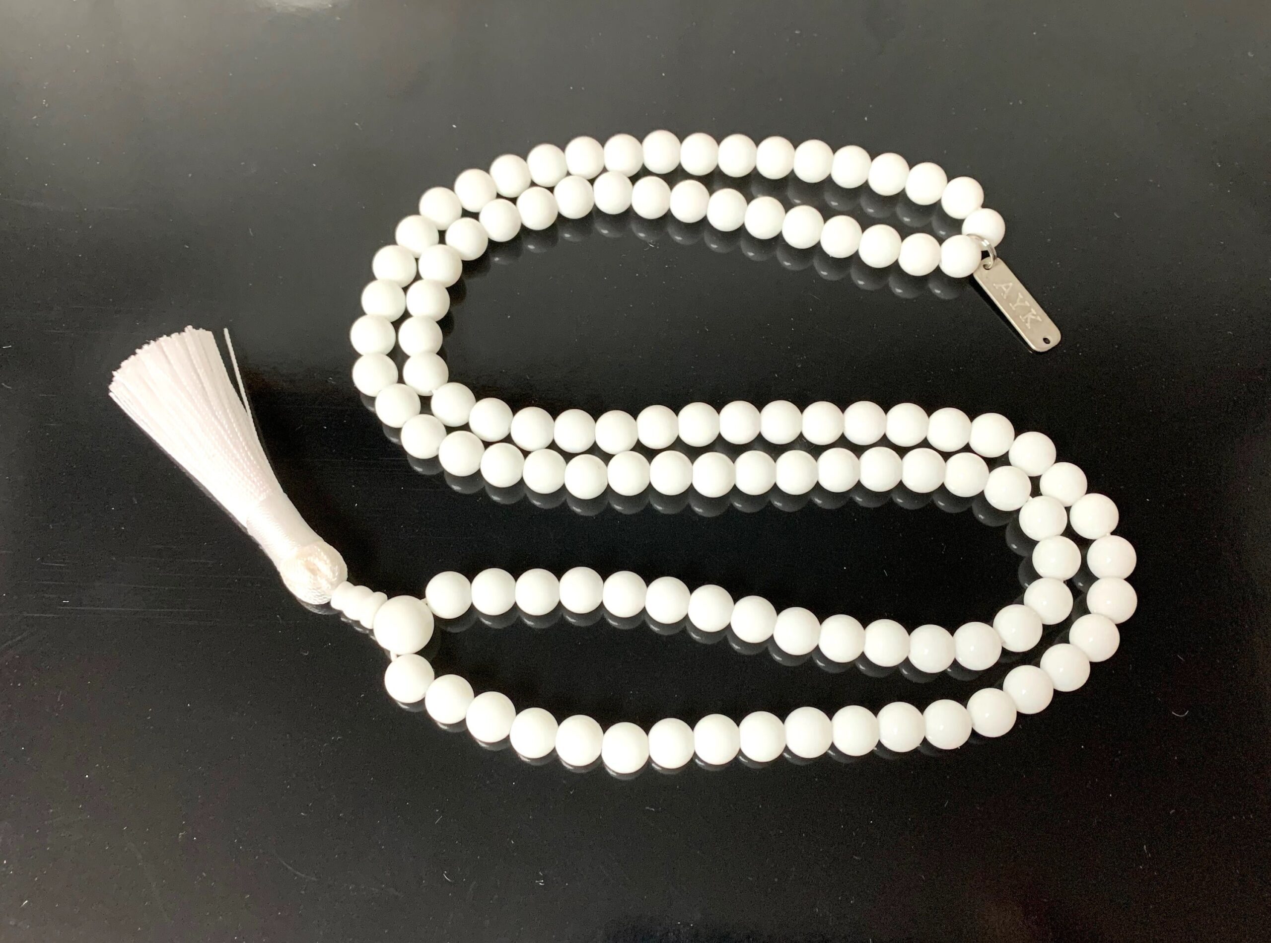 White Jade Mala Necklace featuring 108 hand-knotted White Jade beads, designed to enhance harmony and purity. Ideal for meditation and spiritual practices, aligning with the Crown and Heart Chakras, and resonating with Libra and Pisces.