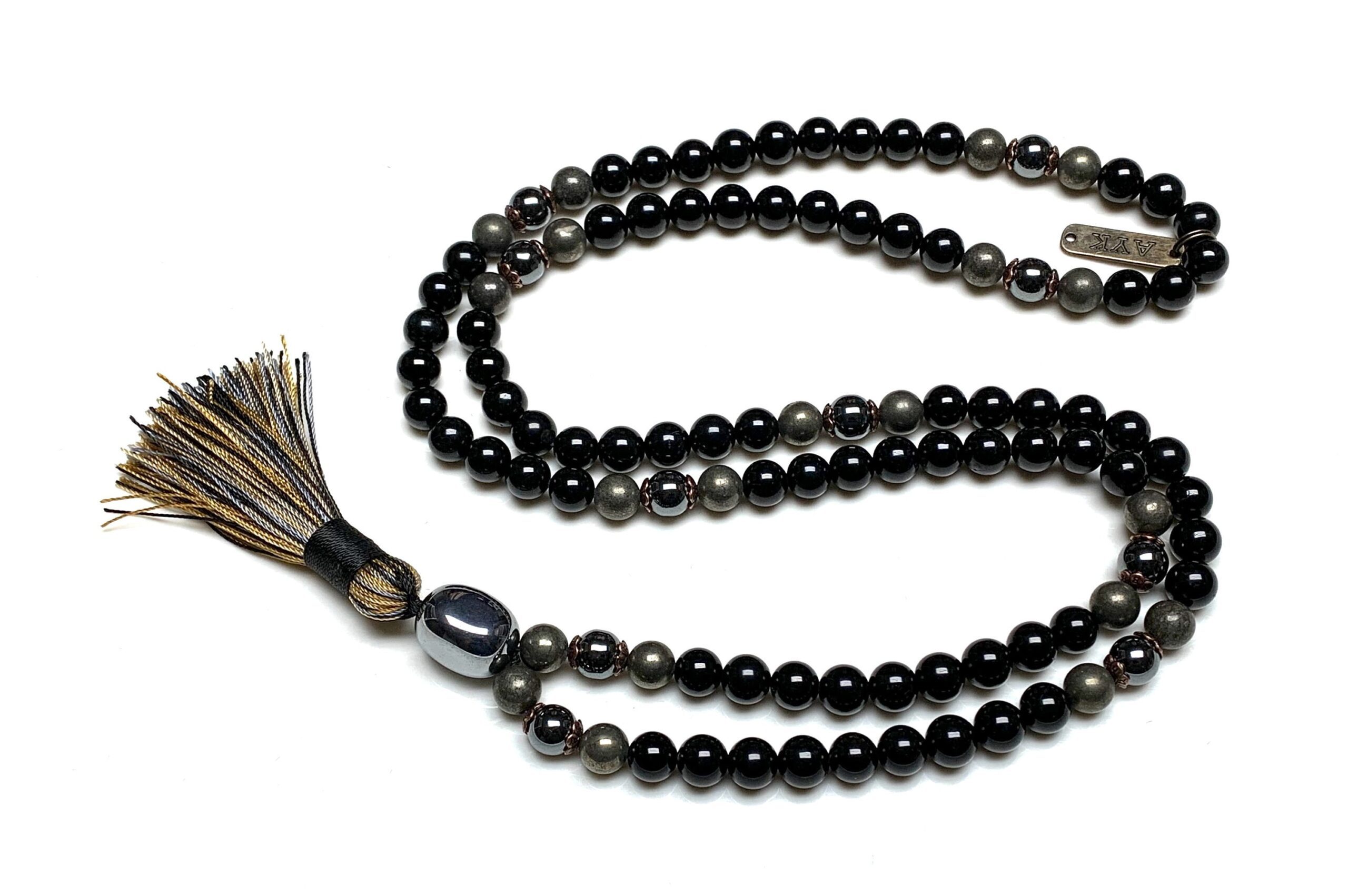 Tourmaline, Pyrite, and Hematite Mala Necklace with 108 hand-knotted beads, designed to activate the Root and Solar Plexus Chakras. Resonates with Capricorn and Scorpio, providing protection, grounding, and inner strength.