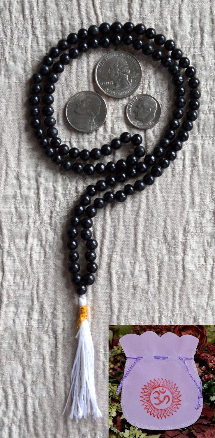 A Black Onyx mala necklace with 108 hand-knotted beads, designed for grounding and protection. Ideal for meditation, featuring smooth, polished onyx beads associated with the Root Chakra and the zodiac signs Capricorn and Leo.