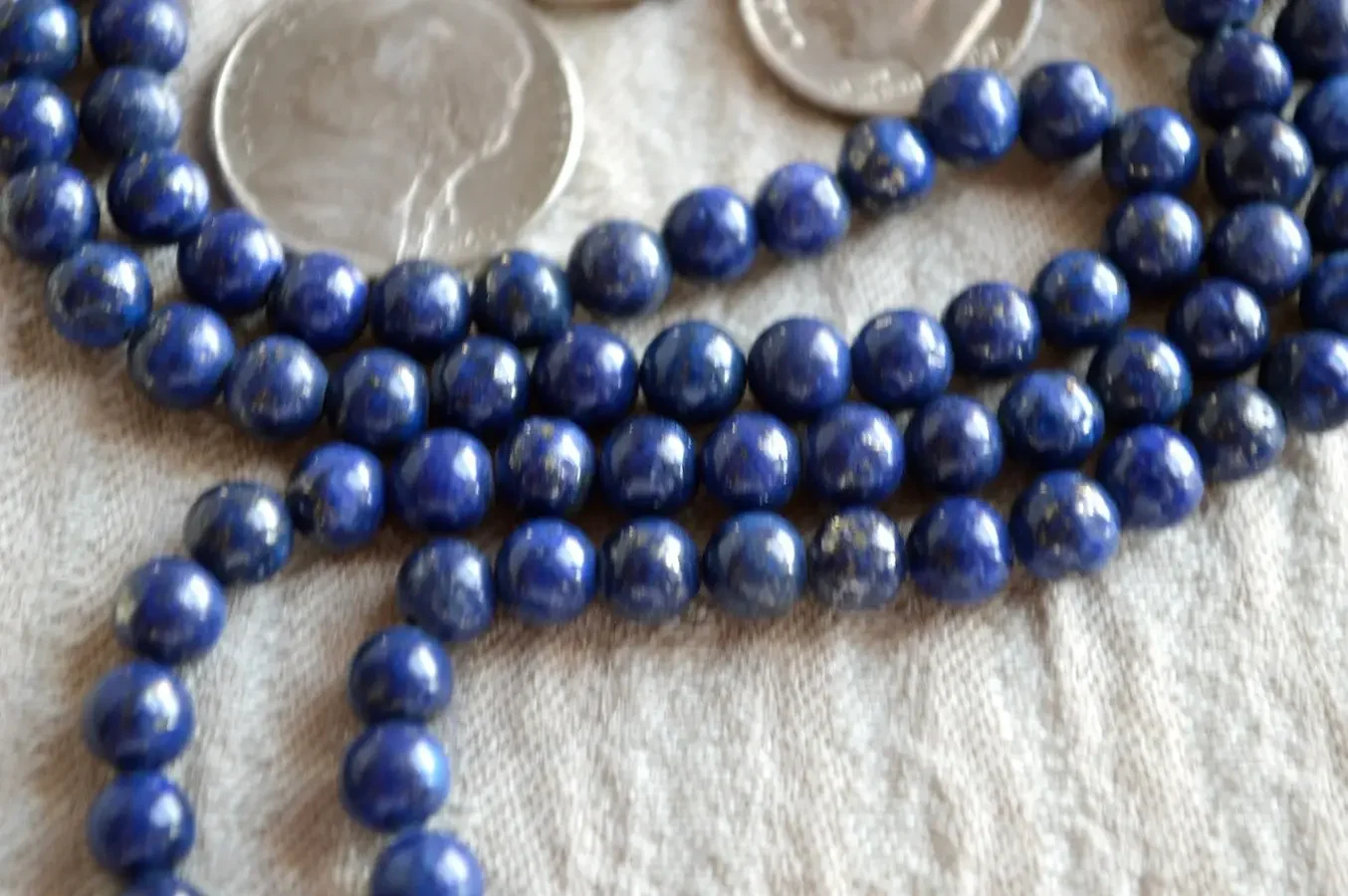 Lapis Lazuli Mala Beads Necklace featuring 108 Lapis Lazuli beads and 1 guru bead. The necklace supports Throat Chakra healing, enhancing wisdom, communication, and self-expression. Handcrafted in the USA, ideal for meditation and as a spiritual accessory.