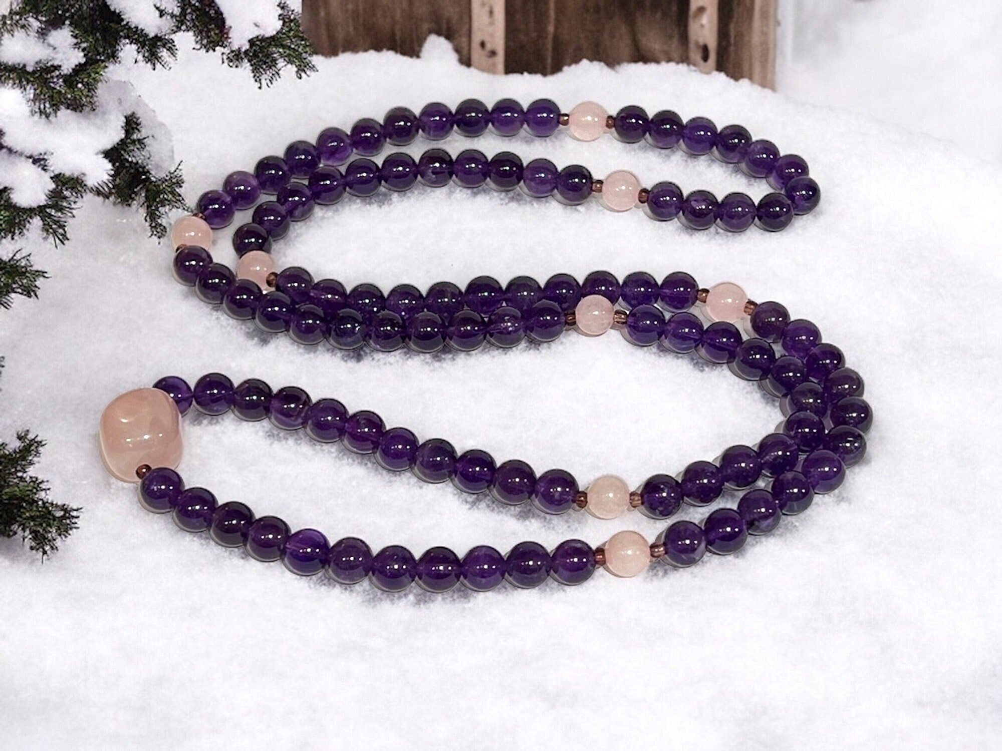 A versatile Amethyst & Rose Quartz Wrap Mala Necklace with 108 beads plus 1 guru bead, supporting the Crown and Heart Chakras, resonating with Pisces. Promotes love, emotional healing, and spiritual awareness. Hand-knotted for meditation and flexibility.