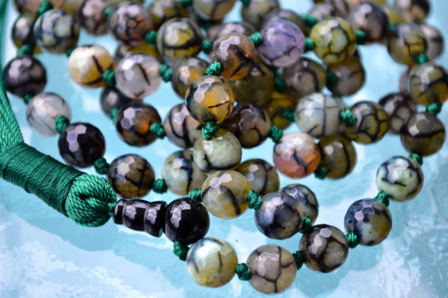 Dragon Vein Agate Mala Necklace with 108 hand-knotted beads, designed to activate the Root and Sacral Chakras. Promotes grounding and enhances creativity, perfect for Aries and Gemini.