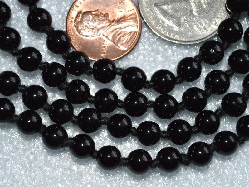 Black Tourmaline Mala Necklace featuring 108 hand-knotted Black Tourmaline beads, designed for protection and grounding. Ideal for meditation and spiritual practices, aligning with the Root Chakra, and resonating with Capricorn and Libra.