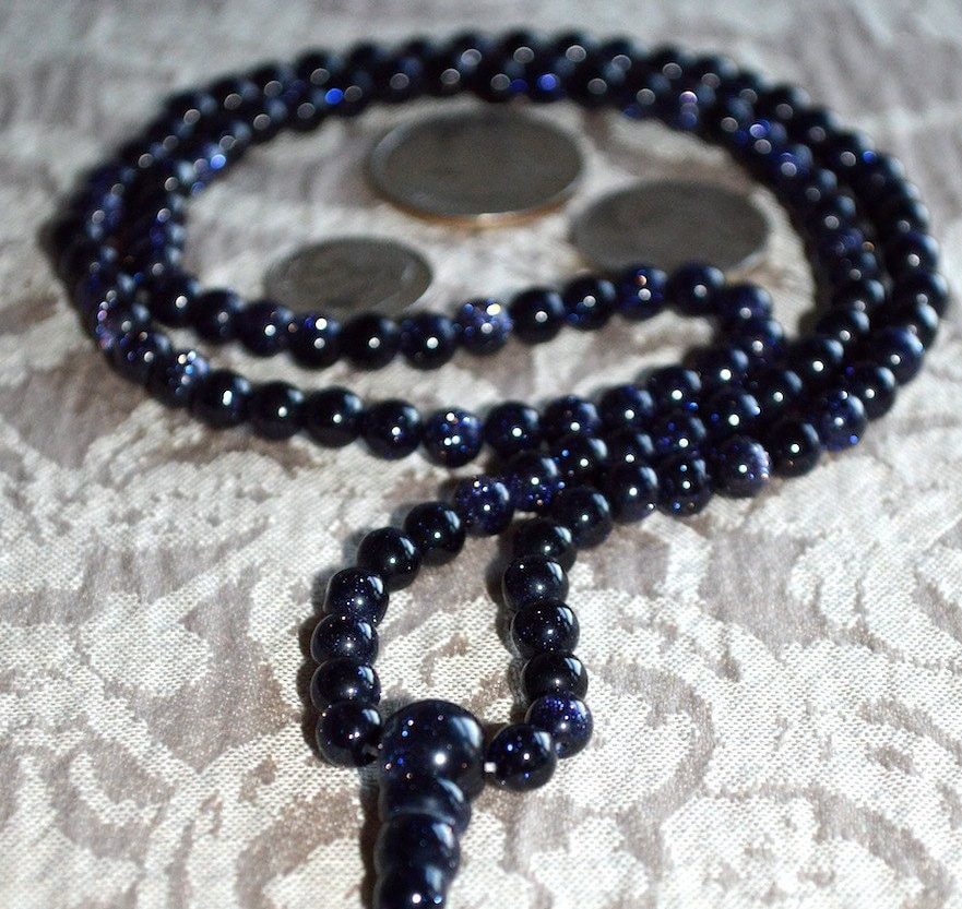 Blue Goldstone / Sandstone Mala Necklace featuring 108 hand-knotted beads, designed to activate the Throat Chakra for enhanced communication and inspiration, associated with Sagittarius energy.