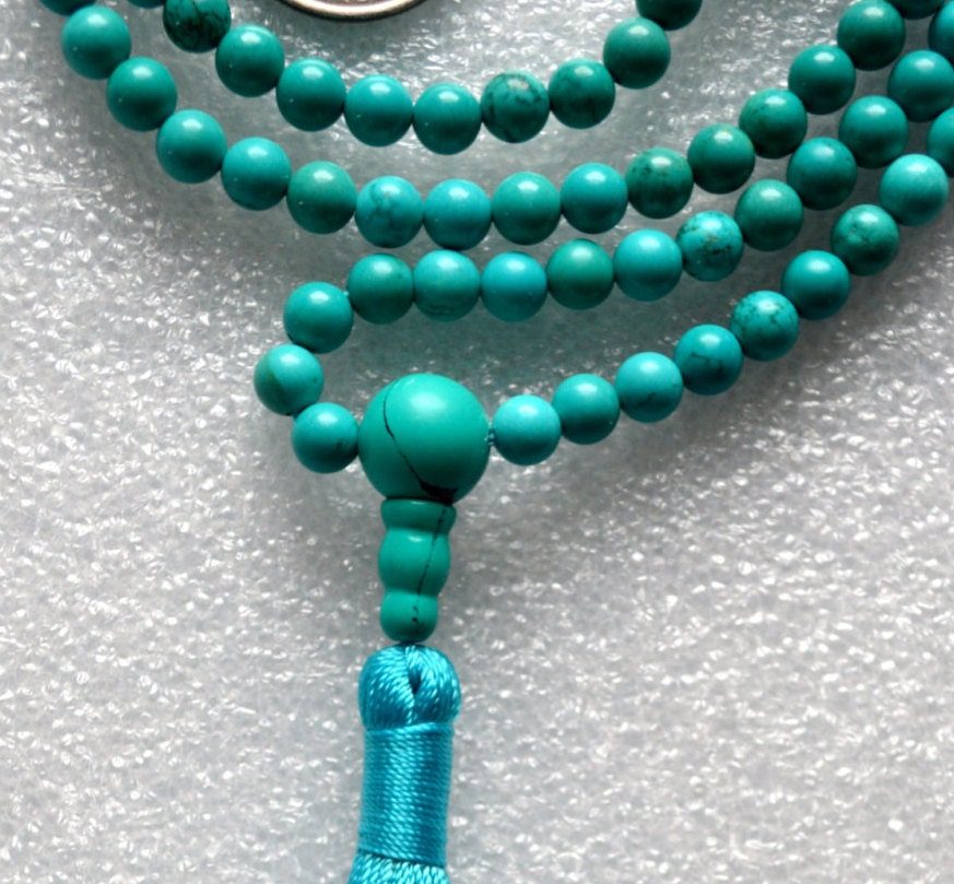 Turquoise Mala Necklace featuring hand-knotted 8mm beads. Ideal for communication and emotional healing, aligns Throat and Heart Chakras. Perfect for Sagittarius and Pisces, and as a December birthstone.