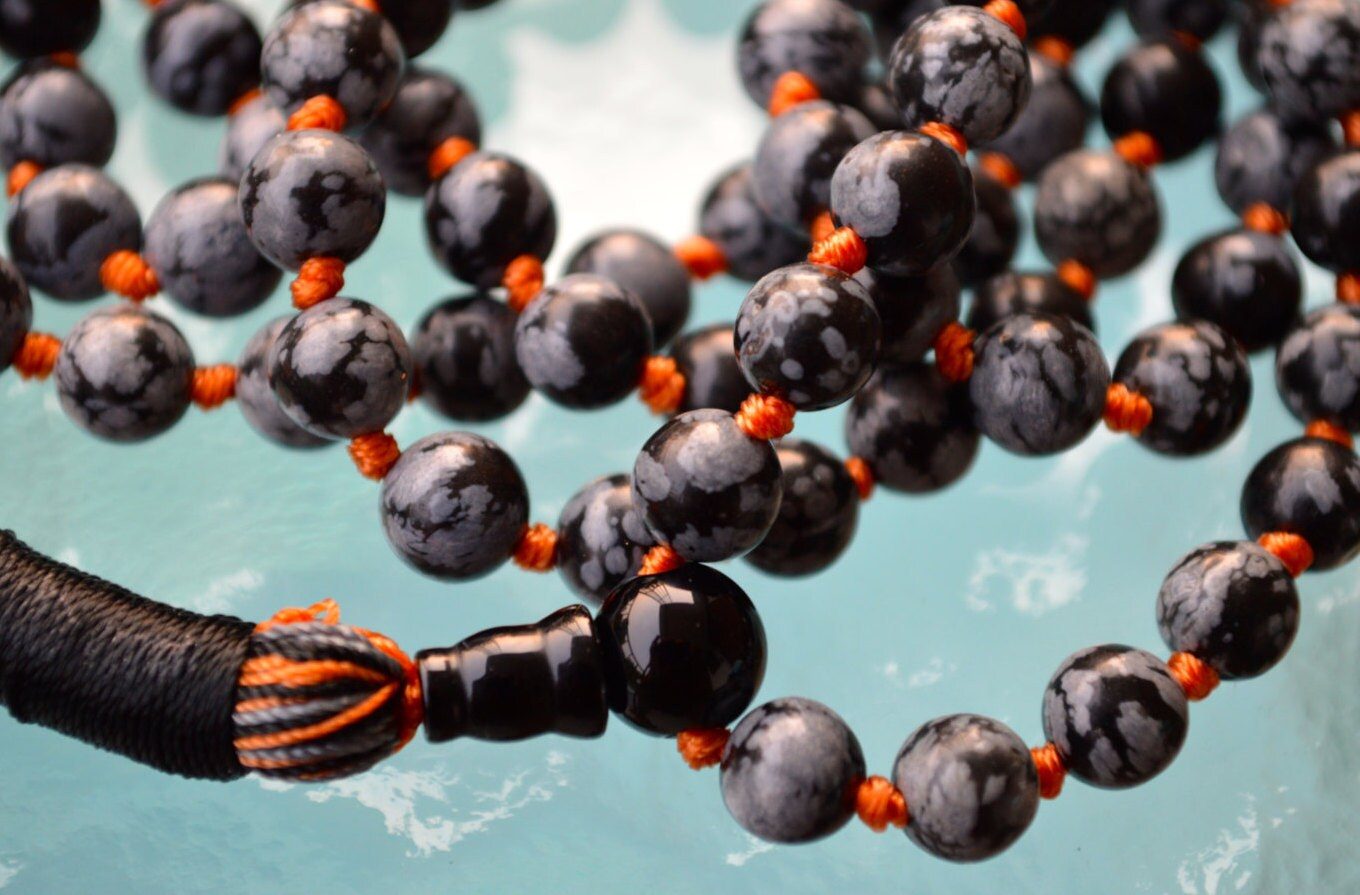 Snowflake Obsidian Mala Beads Necklace designed for Root and Sacral Chakra support, promoting balance, protection, and emotional stability, with stones resonating with Capricorn and Virgo.