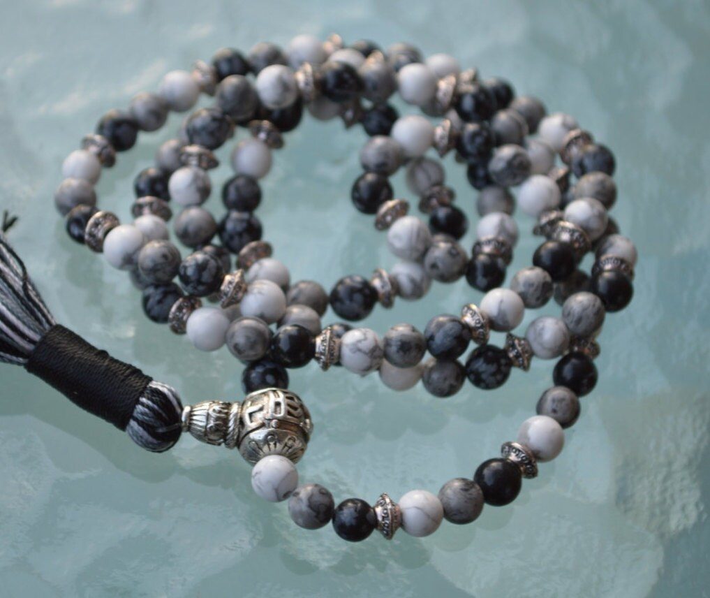 Snowflake Obsidian, White & Black Jade Mala Necklace with 108 hand-knotted beads, designed to balance the Root and Crown Chakras. Resonates with Capricorn and Gemini, offering grounding, protection, and spiritual growth.